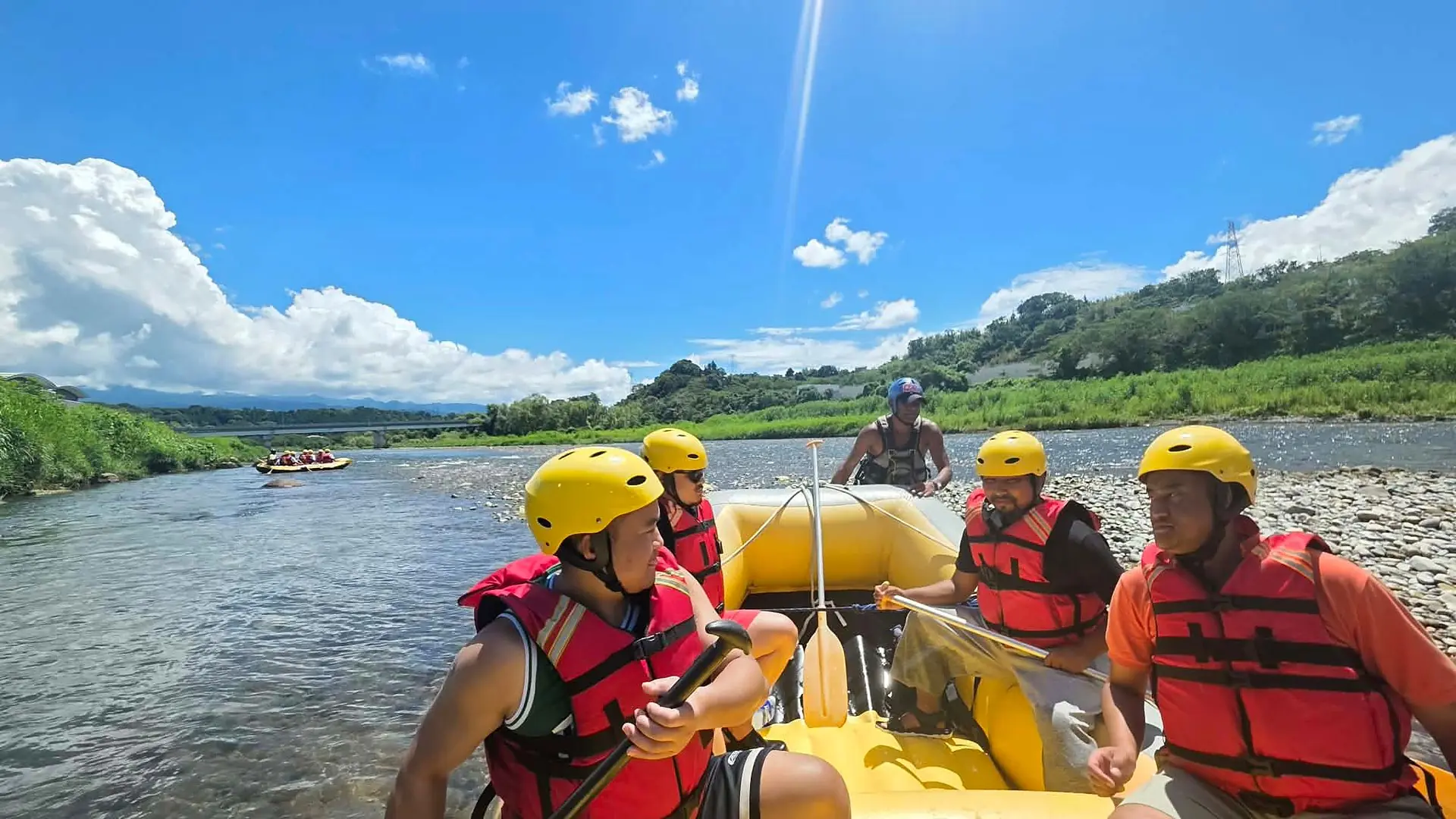 Guests paddling a Dream Adventure raft down the Tone River in Numata, Gunma